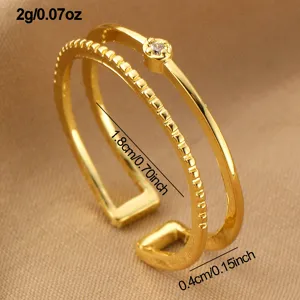 Vergoldeter doppelreihiger offener Ring mit funkelndem Zirkonstein, elegantes Schmuckstück.