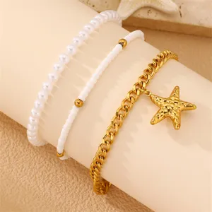 Dreiteiliges, mehrlagiges Armband mit Perlen, weißen Perlen und goldener Seestern-Anhänger Strand.