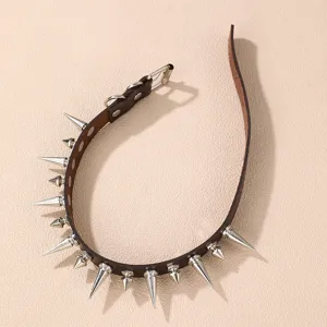 Detail view of punk style brown leather choker necklace with silver spiked metal studs.