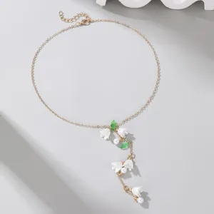Elegant lily of the valley pearl Y-necklace, delicate gold-tone chain, charming floral detail.