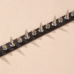 Detail view of punk rock style black leather choker necklace featuring metal spikes and rivets.