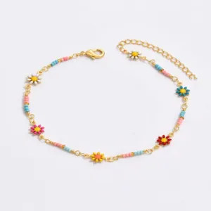 Charming gold-tone metal anklet featuring colorful enamel daisy charms and delicate seed beads.