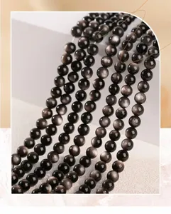 Macro detail of natural silver sheen obsidian round beads with high metallic luster