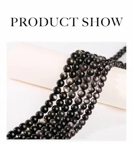 Detail view of natural sheen obsidian round beads showing silver eye effect