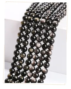 Macro view of natural silver obsidian round beads showing metallic sheen for DIY jewelry