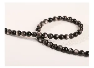 Close-up of silver obsidian round beads showing natural silver sheen for DIY jewelry