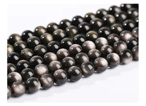 Macro detail view of natural silver sheen obsidian round beads showing metallic luster