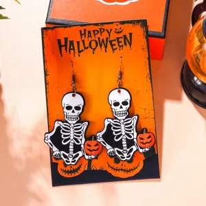 Detailed view of funny Halloween skeleton drop earrings on an orange display card