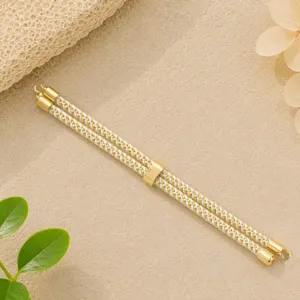 Cordino intrecciato oro e bianco accessorio per braccialetto DIY con estremita metalliche fini.