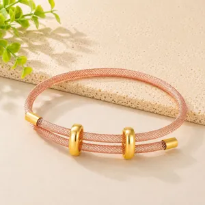Bracciale rigido in rete metallica color oro rosa alla moda con due anelli dorati scorrevoli