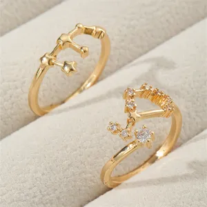 Detailaufnahme von goldenen Sternbild Offenen Ringen mit funkelnden Zirkonia auf Schmucktablett.
