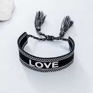 Black and white woven bracelet with love letters and tassels, unisex casual daily wrist jewelry.