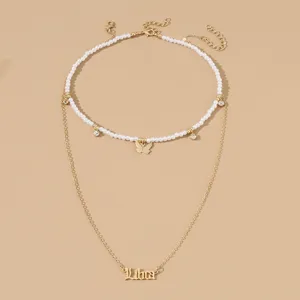 Zweilagige Halskette mit Perlen-Choker, Schmetterlingsanhänger und stilvollem Sternzeichen-Anhänger Libra.