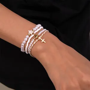 Mehrlagiges Perlen Sternzeichen Armband Set mit Schuetze Anhänger und goldenen Akzenten.