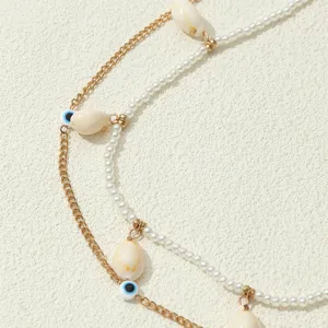 Catena da corpo multistofia perla conchiglia malocchio bohémien spiaggia dettaglio.