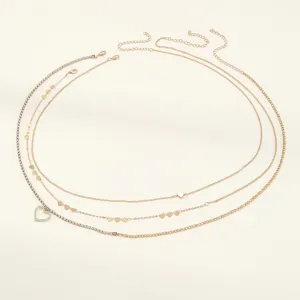 Detailed view of trendy multi-layer gold waist chain featuring sparkling heart charms.