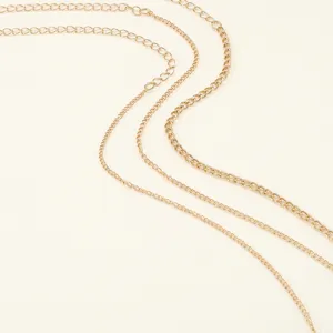 Detailed view of fashionable multi-layer gold metal chains, perfect accessory for design.