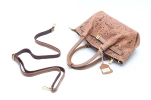 Close up details of vintage floral embossed leather tote shoulder crossbody bag with strap.