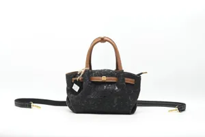 Detailed view of the vintage embossed genuine leather handbag with brown handles and strap.
