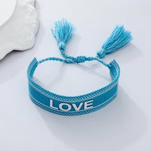 Blue woven bracelet with white LOVE embroidery and cute tassels. Perfect casual couple wrist accessory.