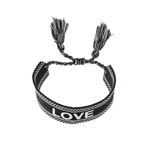 Black and white woven friendship bracelet with tassels and love embroidery for daily wear.