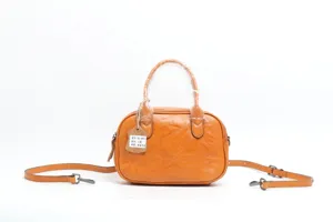 Detail view of retro vegetable tanned leather pillow shoulder bag with metal hardware.