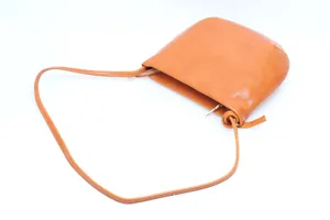 Close-up detail of the brown leather shoulder bag strap and metal zipper hardware.