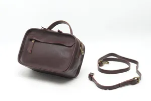 Brown leather Boston handbag with top handle and detachable strap for women daily use.