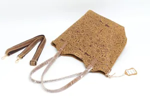 Detailed view of retro floral embossed genuine cowhide leather tote bag with straps.