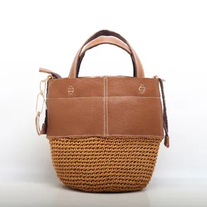 Woven straw and genuine leather bucket bag, stylish retro handbag for women daily use.