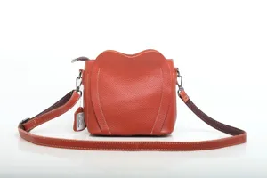 Orange leather crossbody bag, stylish heart shape shoulder bag with adjustable strap.
