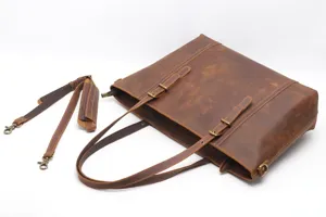 Close-up detail of retro brown genuine leather tote bag showing vintage texture and hardware.