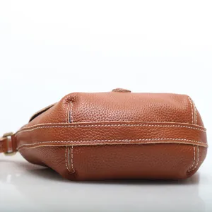 Brown genuine leather women shoulder cross body bag with elegant contrast white stitching.
