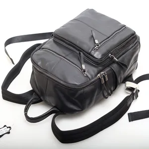 Men black genuine leather business laptop backpack with multi compartments and sturdy zippers.