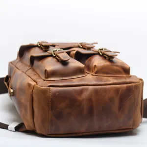 Vintage crazy horse leather men backpack with multi pockets and metal buckles for travel.