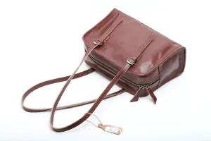 Brown genuine leather shoulder bag for women, vintage tote handbag with double straps detail.