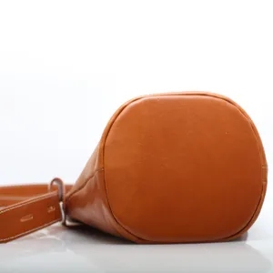Classic brown leather bucket bag with adjustable strap, retro versatile casual handbag.