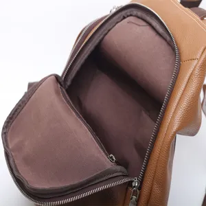 Brown genuine leather backpack for women, stylish daily daypack with zipper pockets.