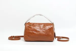 Brown genuine leather Boston bag detail view, classic retro design, premium cowhide material.
