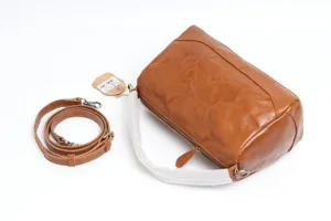 Vintage leather Boston bag detail showing textured cowhide surface, zipper and handle wrapping.
