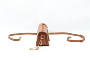 Vintage brown leather cylinder shoulder bag with adjustable strap and side zipper pocket.