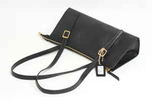 Premium genuine leather shoulder bag for women, stylish black underarm bag with gold buckles.