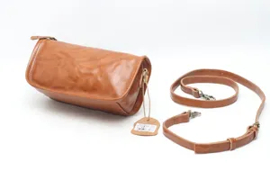 Vintage leather shoulder bag detailed shot, premium cowhide crossbody bag with strap.