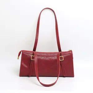 Genuine leather red shoulder bag for women, stylish underarm baguette bag with double straps.
