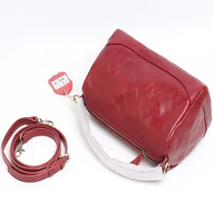 Vintage red genuine leather boston bag with detachable shoulder strap for elegant women commuting.
