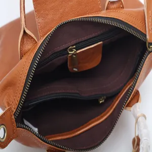 Genuine leather women backpack stylish brown cowhide commute shoulder bag interior pocket.