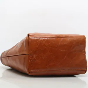 Brown genuine leather women shoulder bag, stylish tote bag with durable stitching and structured base.