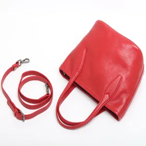Red genuine leather bucket bag with top handles and detachable shoulder strap for women.