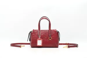 Stylish red genuine leather handbag with top handles and adjustable crossbody strap for women.