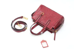 Retro genuine leather handbag with detachable strap, detailed view showing vintage texture and hardware.